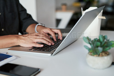 Buy stock photo Shot of an unrecognizable businessman working on his laptop at work