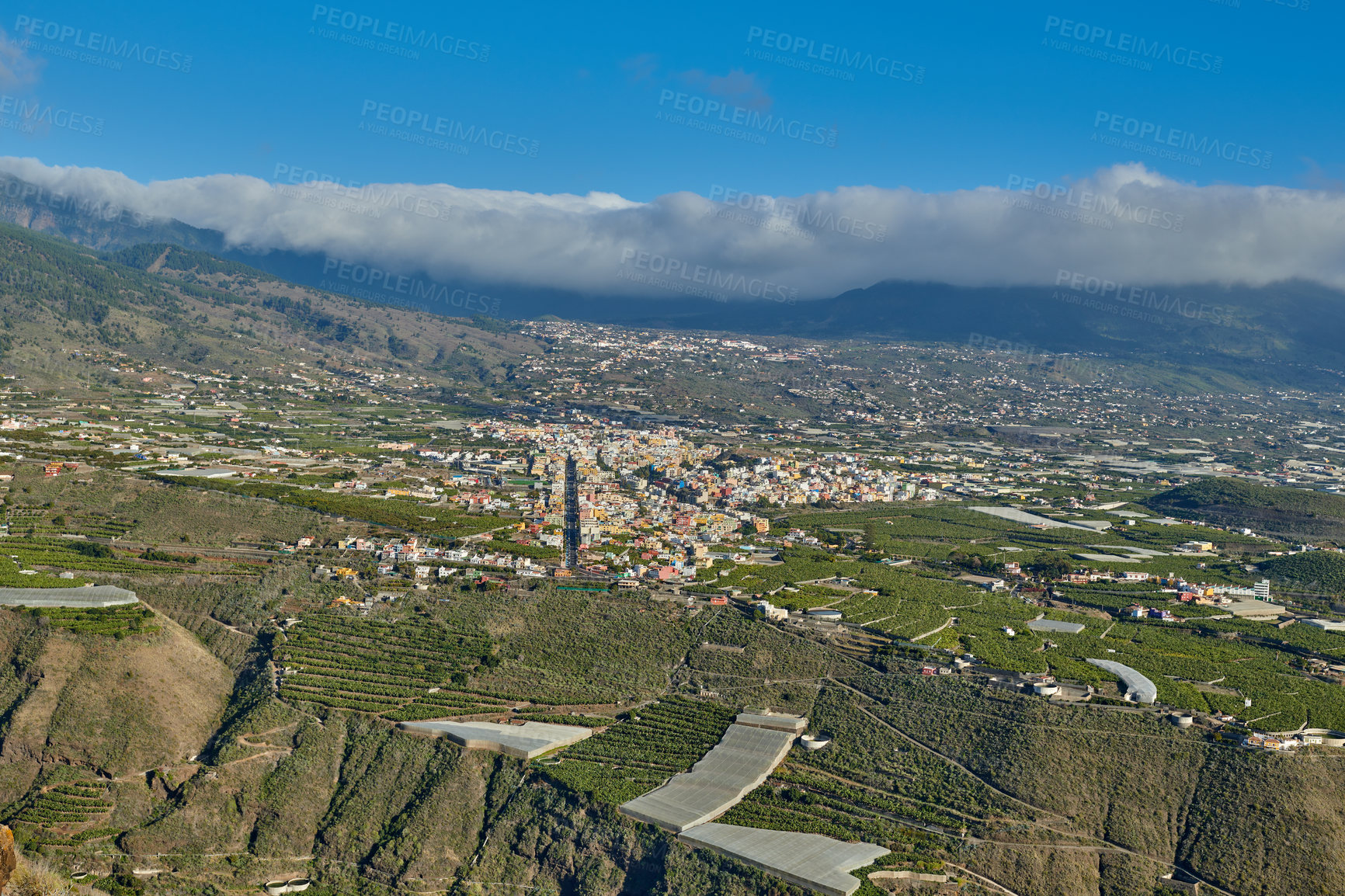 Buy stock photo Beautiful landscape of a small agricultural village on a sunny afternoon near a highway or busy road for logistics or transport of goods. Banana plantations in the town of Los Llanos, La Palma, Spain