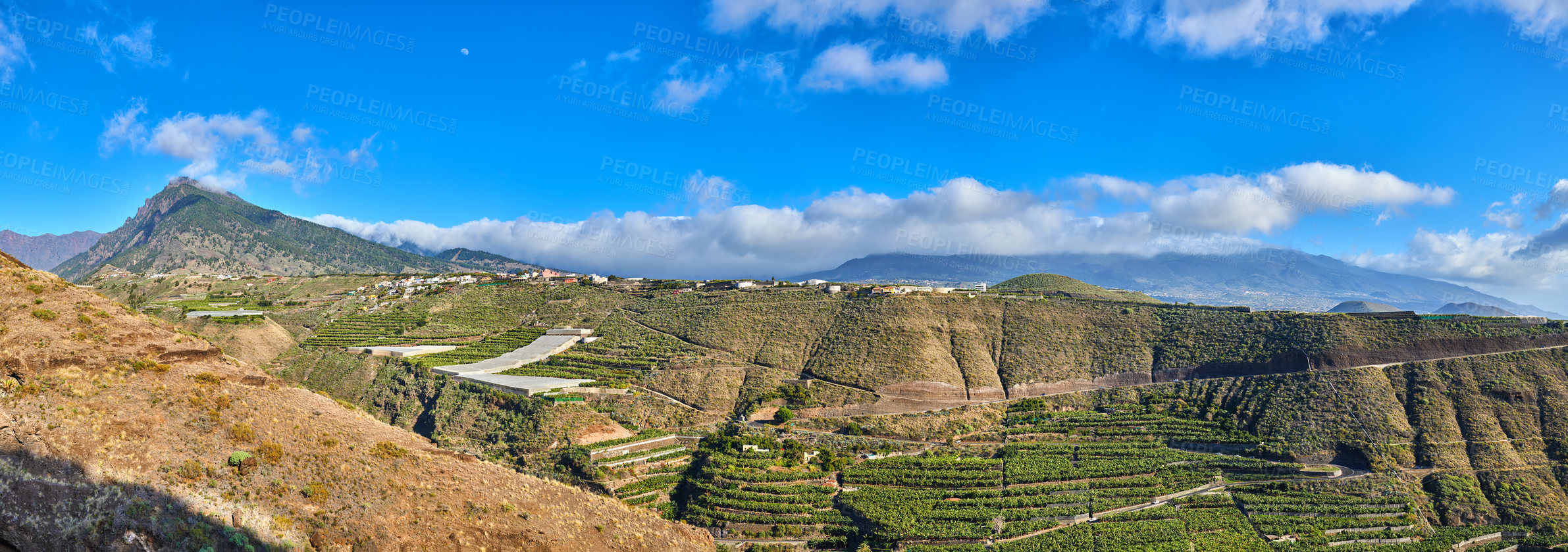 Buy stock photo Landscape view of banana plantations around Los Llanos, La Palma in Spain. Remote farmland on the countryside against a blue sky. Secluded green mountains in a deserted farming town with copy space