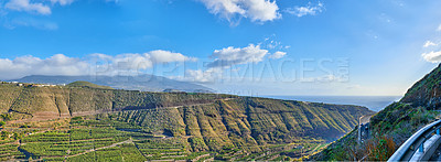 Buy stock photo Beautiful landscape of a small agricultural village on a sunny afternoon near a highway or busy road for logistics or transport of goods. Banana plantations in the town of Los Llanos, La Palma, Spain