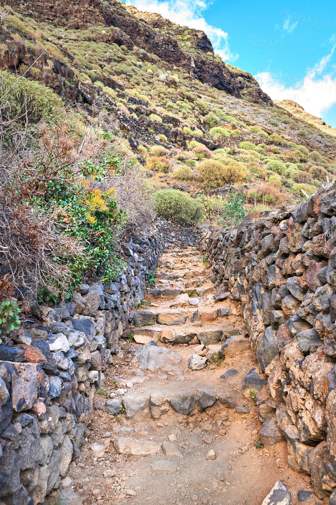 Buy stock photo Mountain, trail or rocks with steps, natural growth or dirt road for trekking adventure or hiking journey in nature. Empty, hill or blue sky with eco conservation, greenery or pathway in wilderness