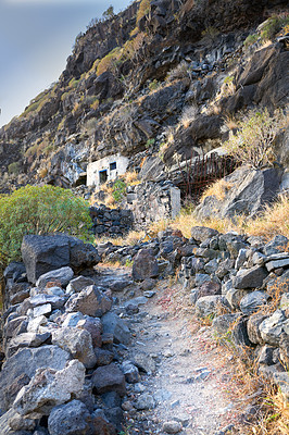 Buy stock photo Mountain, hill and ruins of house outdoor for history site, cultural heritage and architecture monument. Landscape, nature and stones with path, ancient landmark and abandoned building of destruction