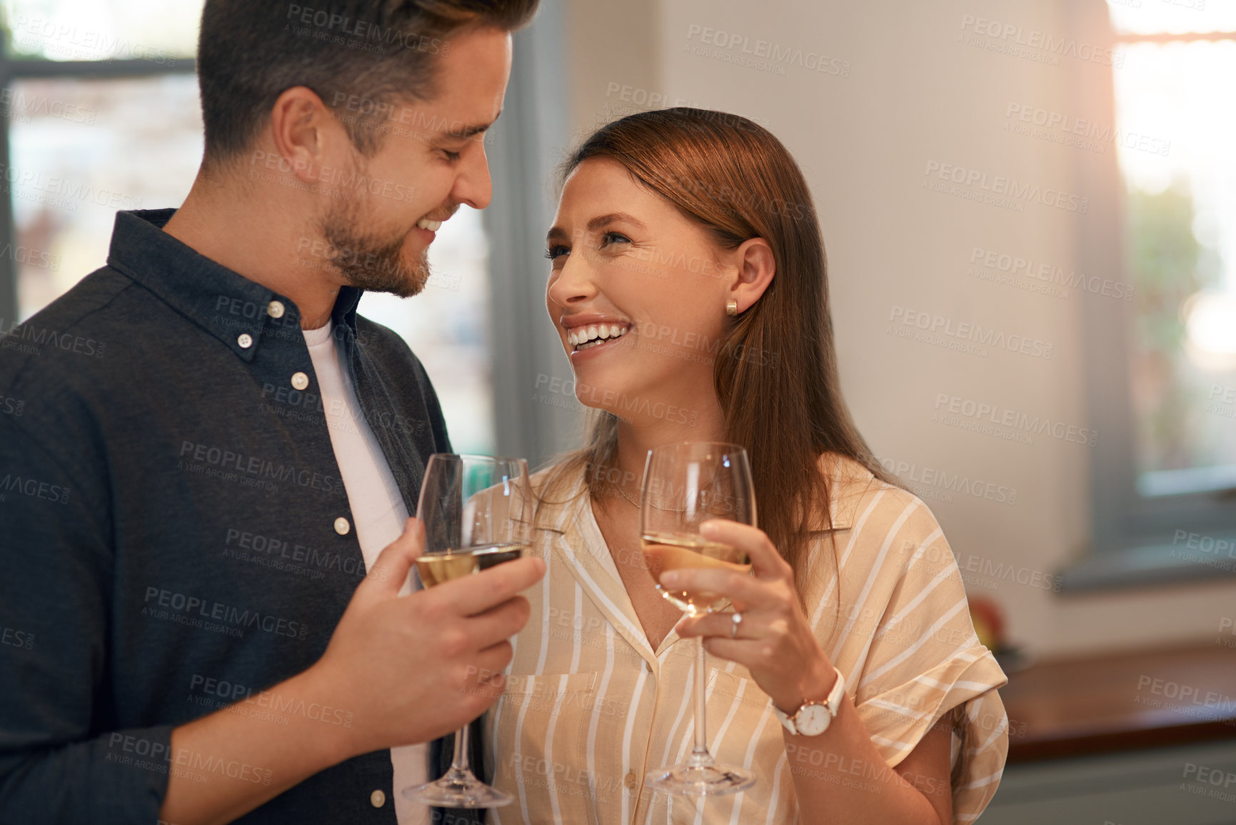 Buy stock photo Champagne, toast and happy couple in a house with love, trust or celebration for birthday, anniversary or good news. Wine, cheers or people in home party for real estate, success or investment growth