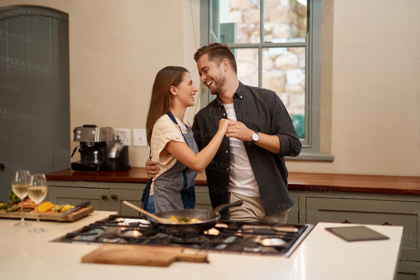 Buy stock photo Cropped shot of an affectionate couple standing together in the kitchen at home