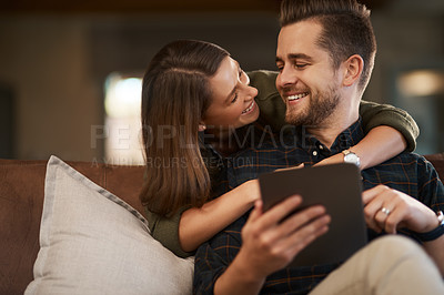 Buy stock photo Home, hug and couple with tablet, love and search for restaurant or social media post with romance in lounge. Apartment, embrace or woman with man on couch and tech with online reading or digital app