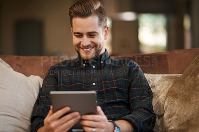 Buy stock photo Cropped shot of a young man relaxing on the sofa at home