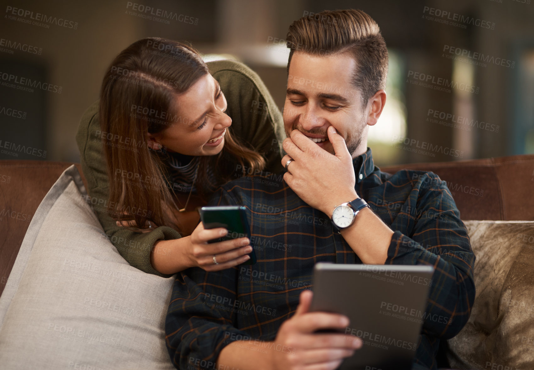 Buy stock photo Happy couple, laugh and sofa with tablet and cellphone for streaming video, social media and online apps for relationship in home. Man, woman and tech in house on internet, affection or loving indoor