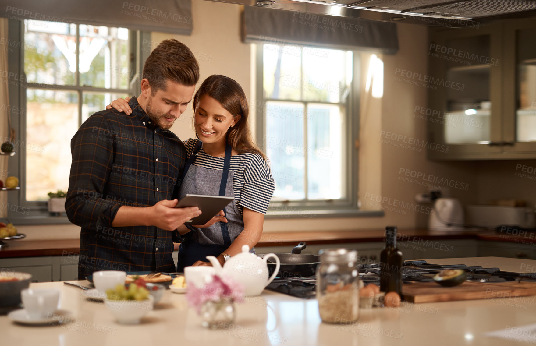 Buy stock photo Couple, cooking and tablet for online recipe in home or ingredients on digital food app, meal or internet. Man, woman and happy in kitchen for wellness nutrition or dinner together, website or health