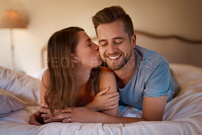 Buy stock photo Shot of a loving young couple spending quality time together in their bedroom