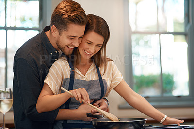Buy stock photo Couple, cooking and pan at stove for dinner nutrition with love embrace for meal, bonding or home. Man, woman and stirring food for healthy diet in kitchen for connection in apartment, smile or hug