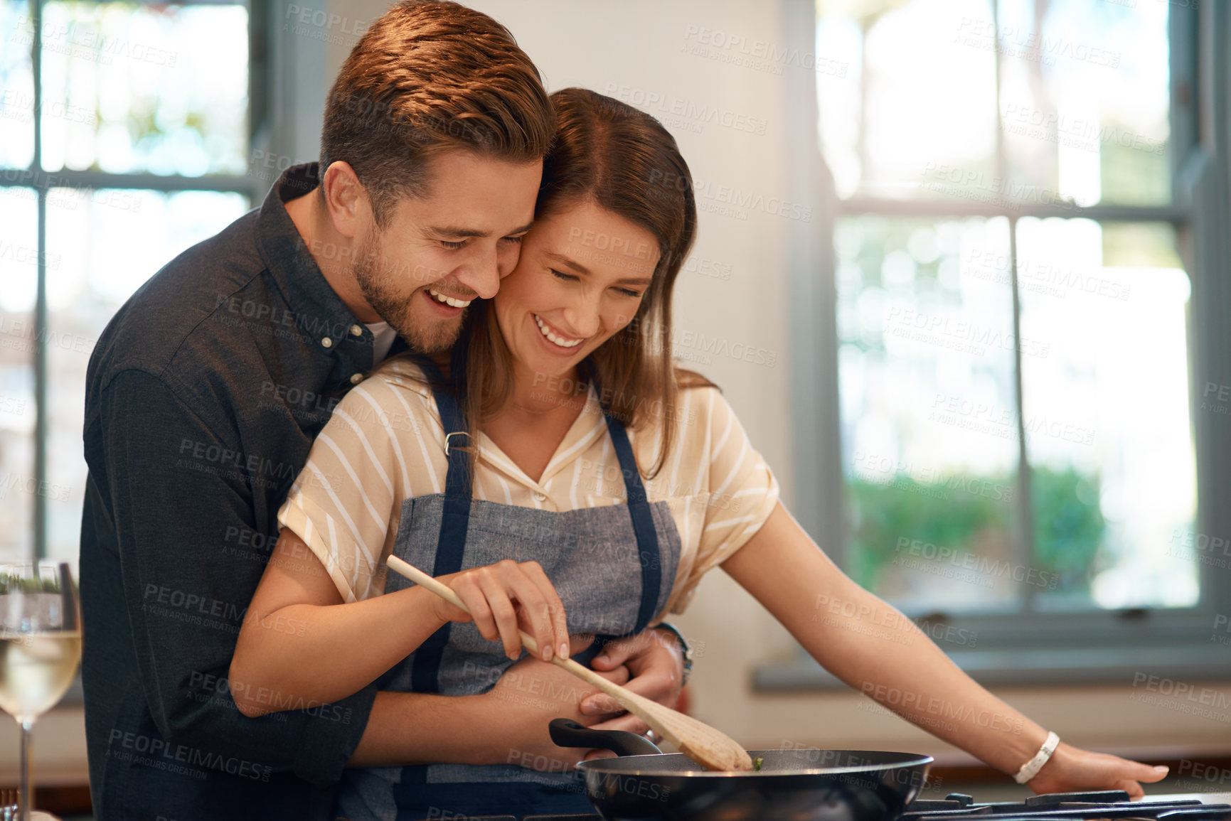 Buy stock photo Couple, cooking and pan at stove for dinner nutrition with love embrace for meal, bonding or home. Man, woman and stirring food for healthy diet in kitchen for connection in apartment, smile or hug