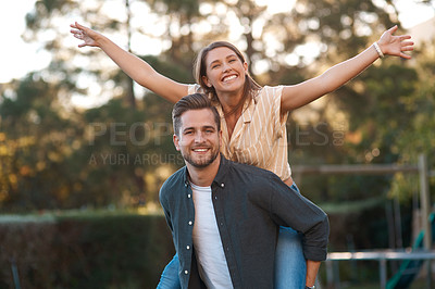 Buy stock photo Man, woman and portrait with piggyback outdoor for relationship connection, anniversary or celebration. Happy couple, face and romance date in garden with airplane game for fun, playing or bonding