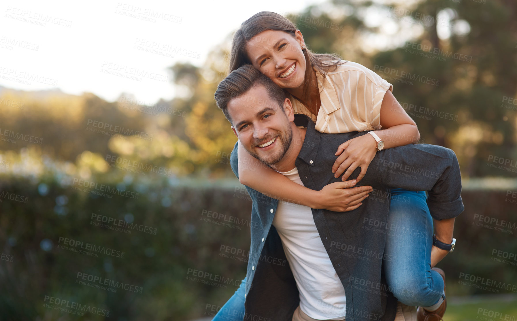 Buy stock photo Man, woman and portrait with piggyback in park for relationship connection, anniversary or celebration. Happy couple, face and romance date in nature together for travel exploring, forest or marriage