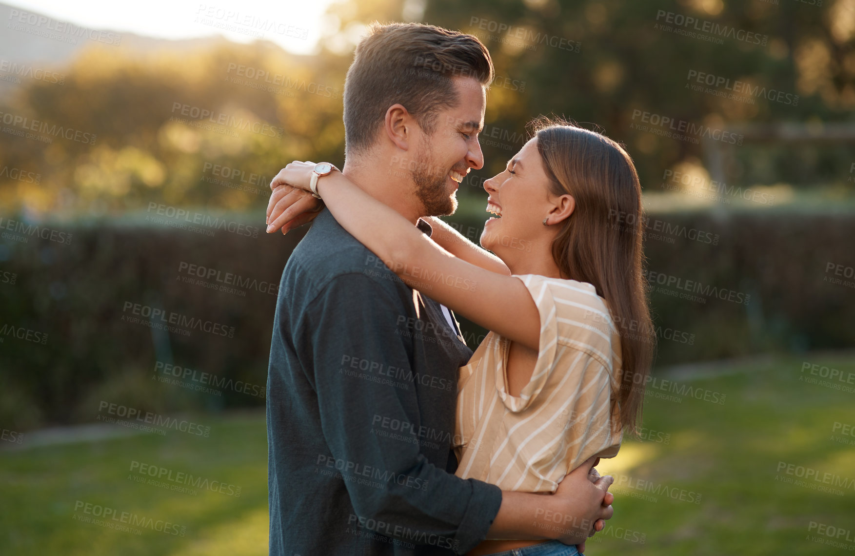 Buy stock photo Couple, hug and laughing in garden park for relationship funny joke with bonding, embrace or humor. Man, woman and happy at sunset for honeymoon travel in Australia with  loving, date or anniversary