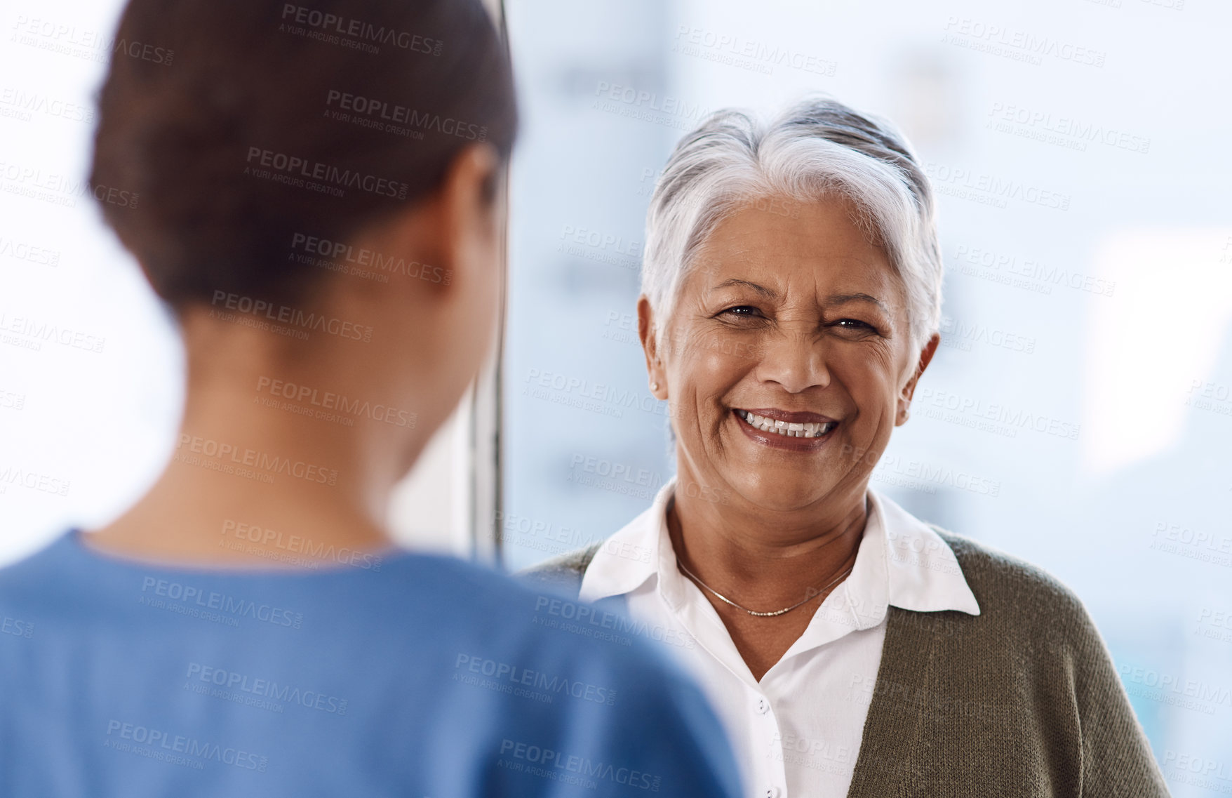 Buy stock photo Healthcare, happy or nurse talking to an old woman about treatment in a nursing home facility clinic. Elderly face, smile or female medical worker speaking to a senior patient in a hospital visit 