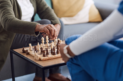 Buy stock photo Hands, chess a nurse with a patient in a nursing home playing a game of strategy during a visit. Healthcare, medical or insurance with a medicine professional and resident in the living room together