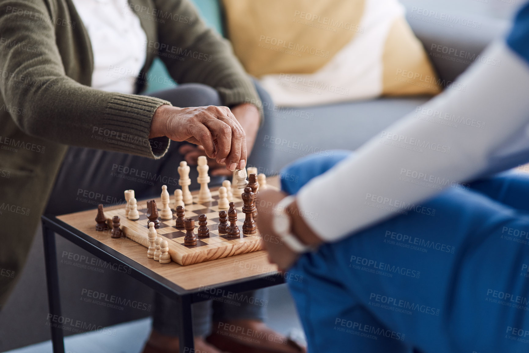 Buy stock photo Hands, chess a nurse with a patient in a nursing home playing a game of strategy during a visit. Healthcare, medical or insurance with a medicine professional and resident in the living room together