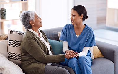 Buy stock photo Support, caregiver holding hands with a senior woman and on sofa at nursing home for care. Consulting or healthcare conversation, communication with nurse and elderly female patient talking on couch
