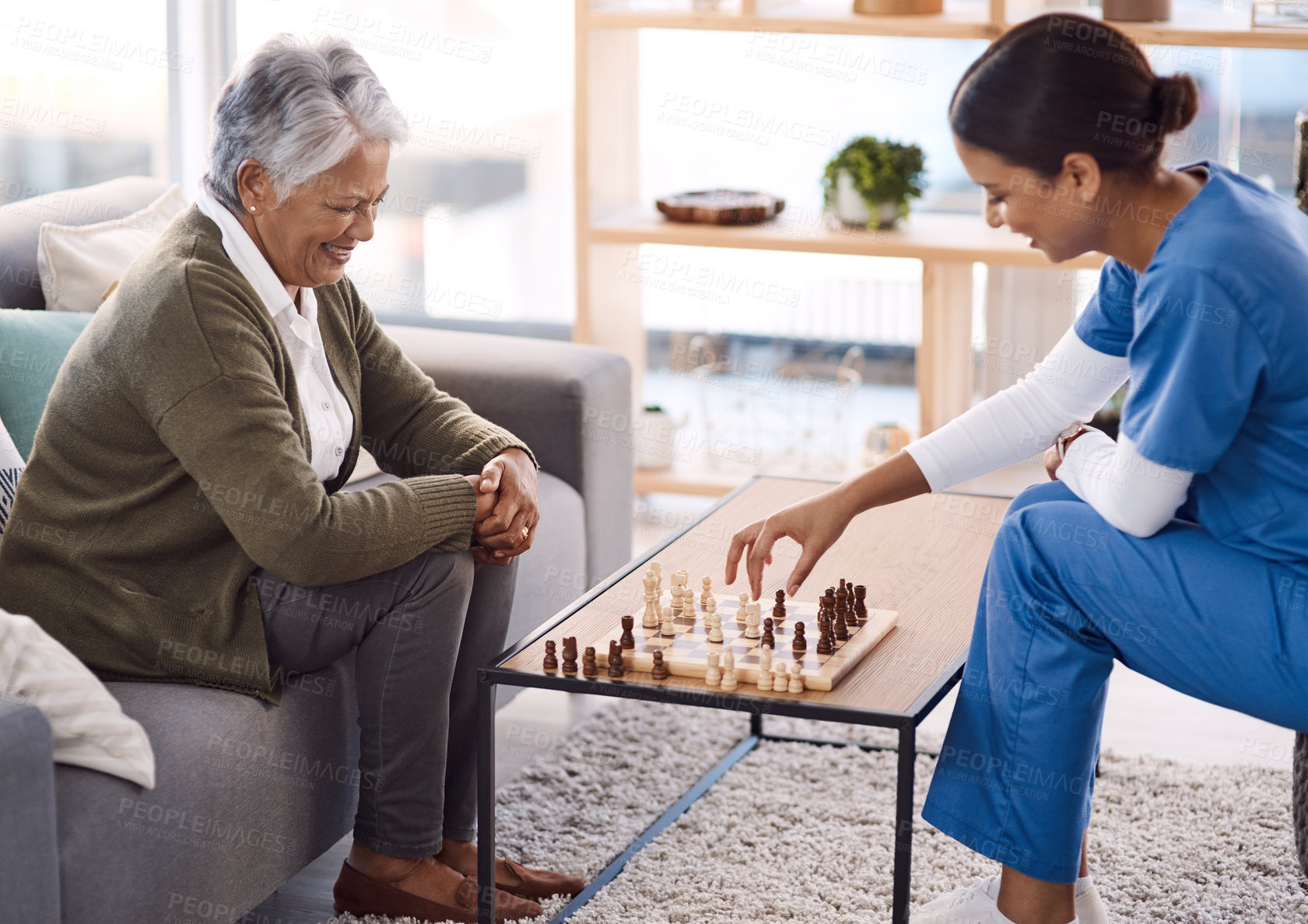 Buy stock photo Women, chess and nurse with a senior patient, retirement home and happiness with healthcare. Female person, medical professional and mature lady with employee, nursing and care with games and relax