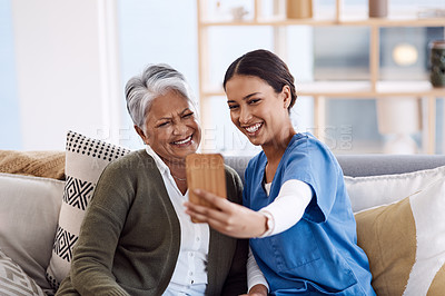 Buy stock photo Shot of a young nurse taking selfies with a senior woman in a retirement home