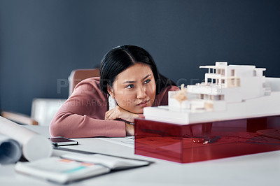 Buy stock photo Woman, architect and thinking by model on desk for idea, progress and inspiration for solution. Person, engineer and property developer with building, house and problem solving at agency in Jakarta