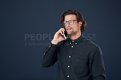 Buy stock photo Businessman, glasses and talking with phone call in discussion or communication on a dark studio background. Handsome, geek or young man speaking on mobile smartphone for conversation on mockup space