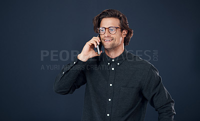 Buy stock photo Happy man, glasses and talking with phone call in discussion or communication on a dark studio background. Handsome, geek or male person speaking on mobile smartphone for conversation on mockup space