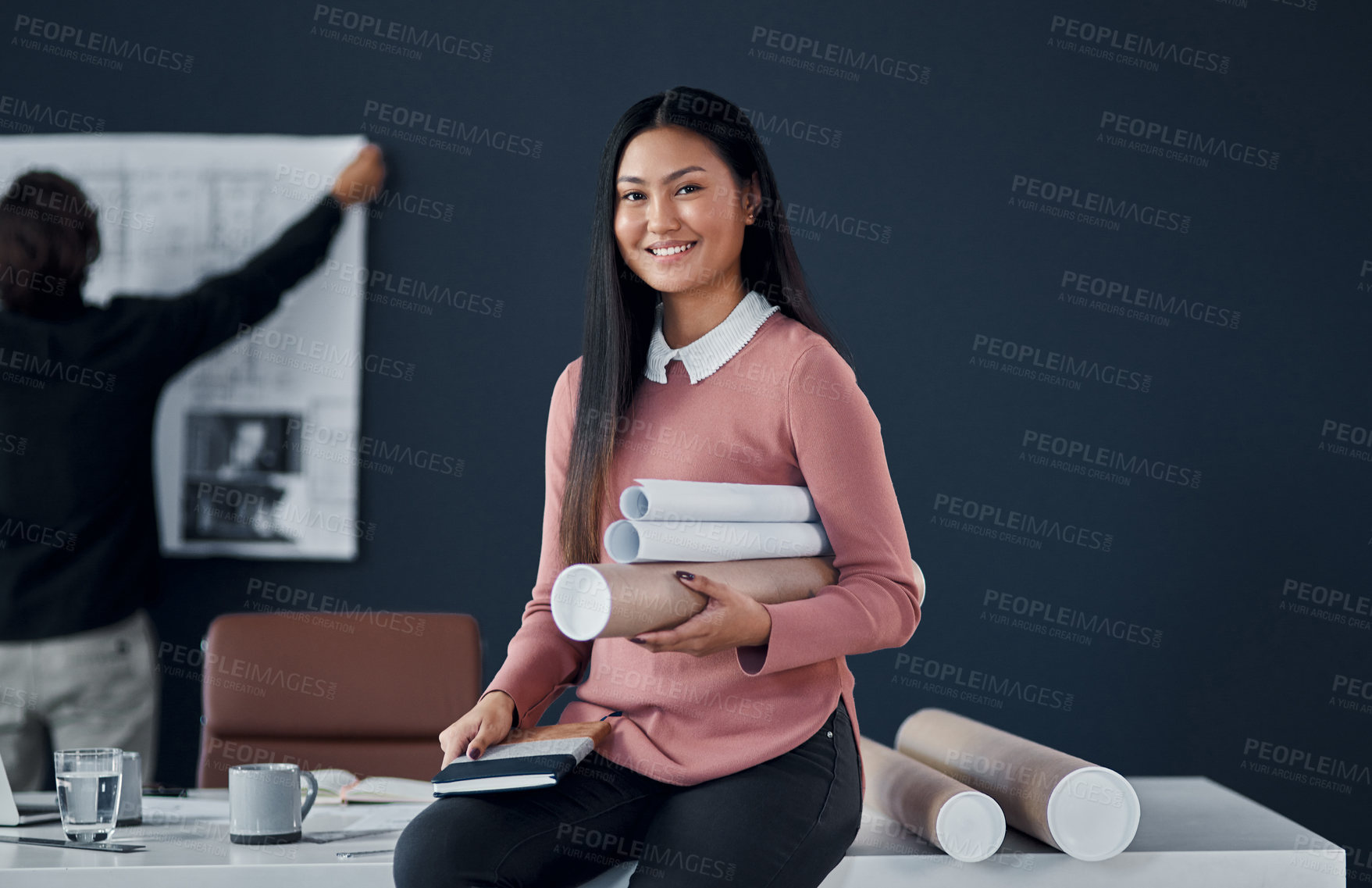 Buy stock photo Asian architect, woman and portrait with roll of sketch paper, documents or smile at small business. Person, property developer and happy for blueprint in construction, building or project in Jakarta