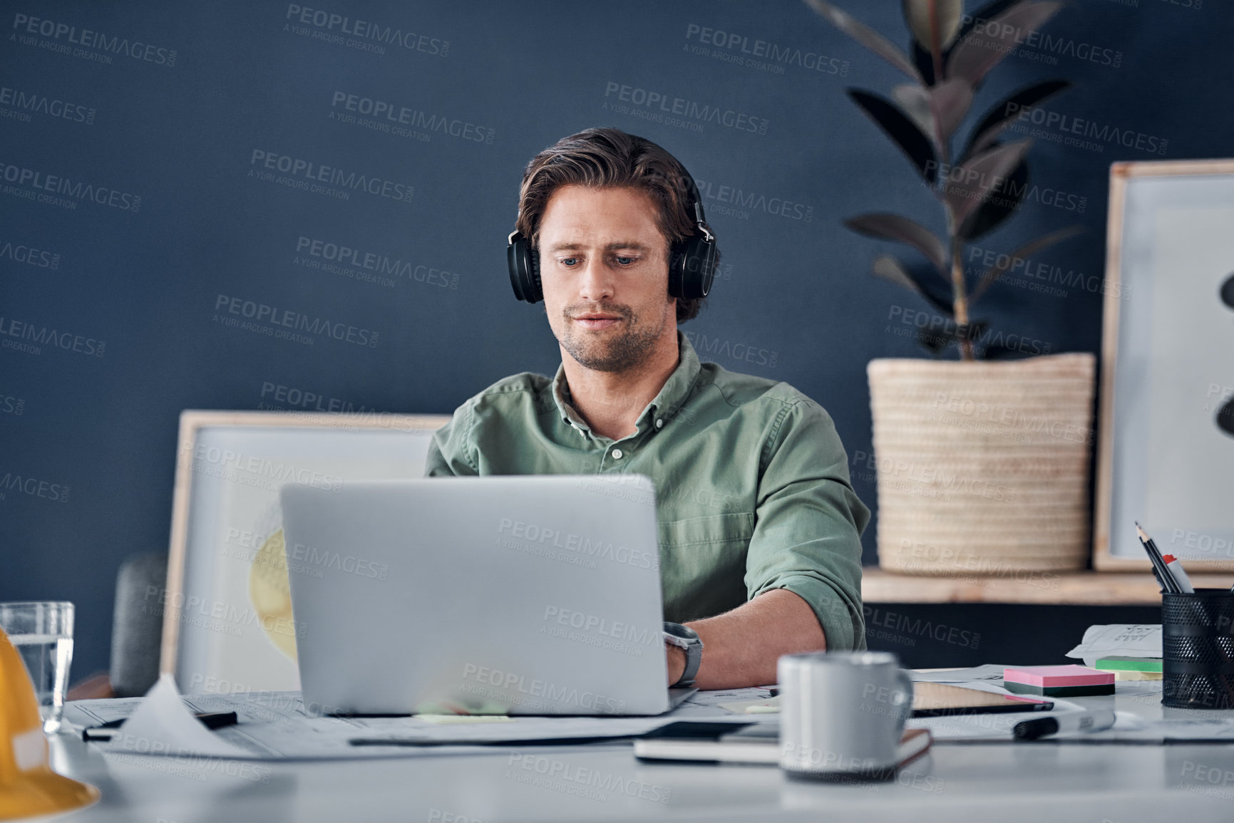 Buy stock photo Music headphones, man and architect on laptop in office streaming radio podcast. Computer, audio or male designer listening to sound or song and working on design, research or engineering floor plan