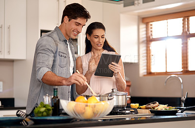 Buy stock photo Cropped shot of a young couple cooking together at home