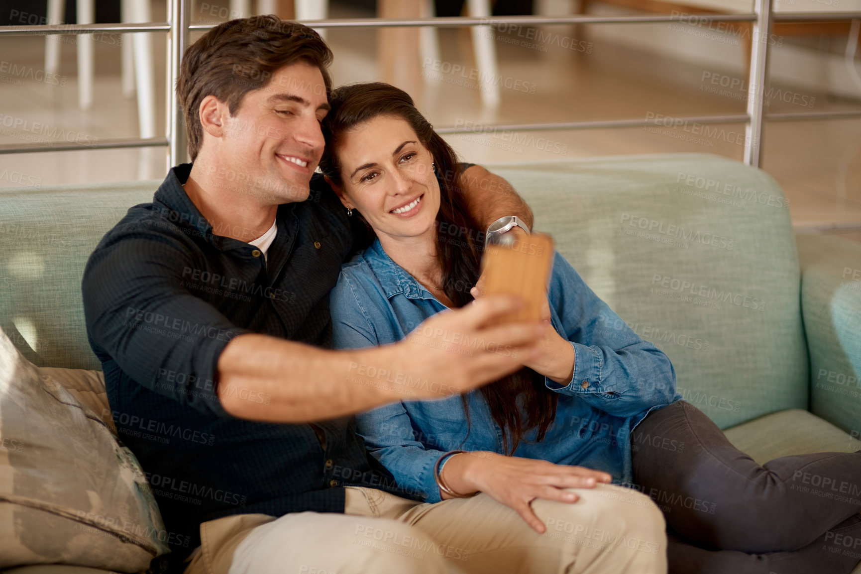 Buy stock photo Young couple, sofa and selfie in home with smile, hug or happiness for love, care and web app. Man, woman and happy for photography, profile picture and social media with bond, relax and lounge couch