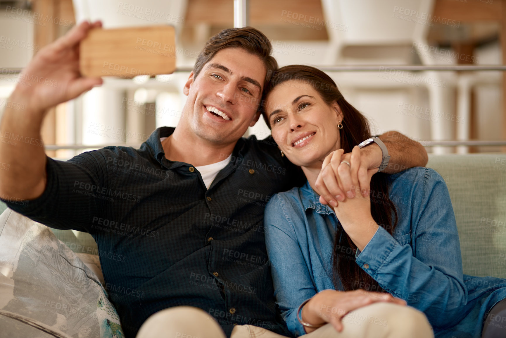 Buy stock photo Couple, couch and selfie in home for smile, holding hands or pride for love, care or internet app. Man, woman and happy for photography, profile picture or social media for bond, relax or lounge sofa