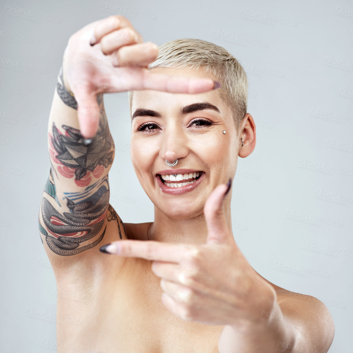 Buy stock photo Woman, finger frame and makeup in studio portrait with smile, beauty and piercings by white background. Girl, model and person with cosmetics, happy and tattoos skincare with photography icon in USA