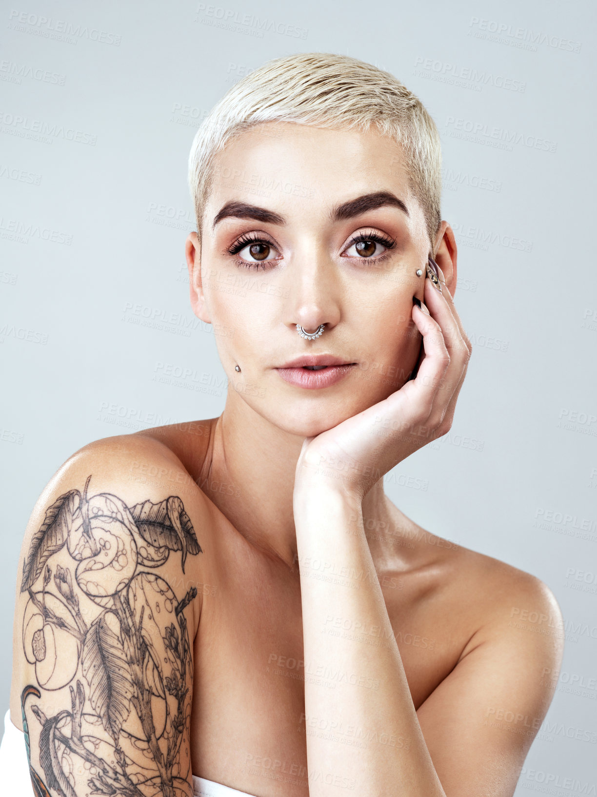 Buy stock photo Studio portrait of a beautiful young woman posing against a grey background