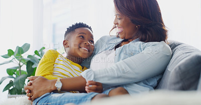 Buy stock photo Shot of a young mother bonding and spending time with her adorable little boy at home