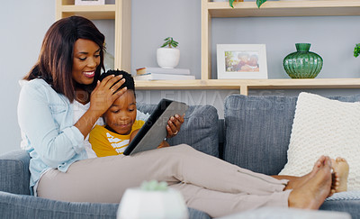 Buy stock photo Full length shot of a young mother and her adorable little boy using a digital tablet together at home