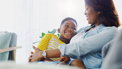 Buy stock photo Shot of an adorable little boy bonding and spending time with his mother at home