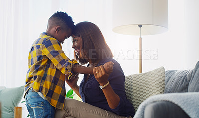 Buy stock photo Shot of an adorable little boy bonding and spending time with his mother at home