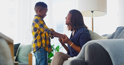 Buy stock photo Shot of an adorable little boy bonding and spending time with his mother at home