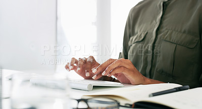 Buy stock photo Cropped shot of businesswoman using a computer at her desk in a modern office