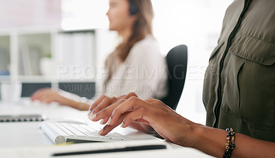 Buy stock photo Cropped shot of an unrecognisable woman using a computer in a call centre