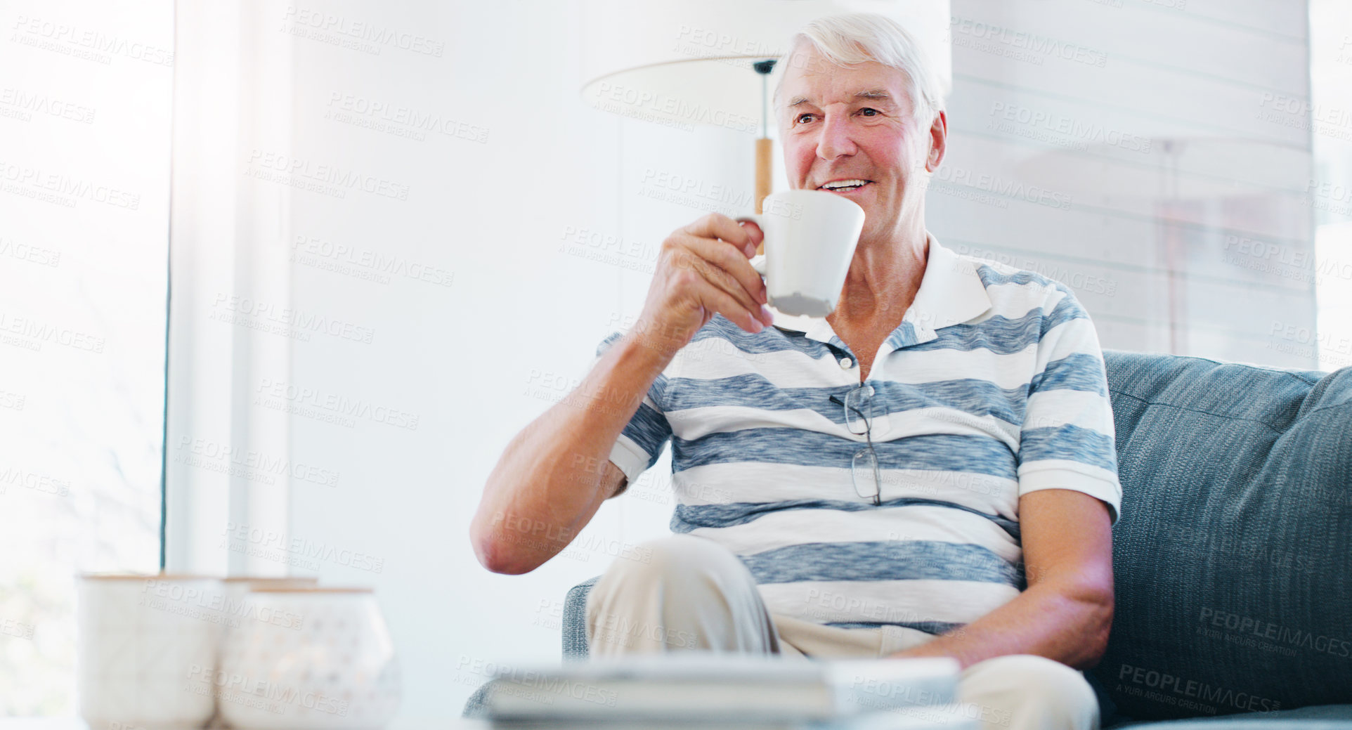 Buy stock photo Coffee, relax and senior man on couch with morning routine, warm drink and weekend peace for wellness. Smile, resting and elderly person with tea cup in home, comfortable and beverage for retirement