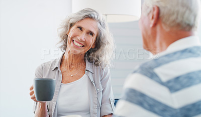 Buy stock photo Shot of a senior couple enjoying a relaxing coffee break on the sofa at home