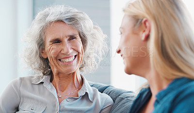 Buy stock photo Shot of a young woman spending quality time with her mother at home
