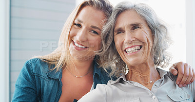 Buy stock photo Shot of a young woman spending quality time with her mother at home