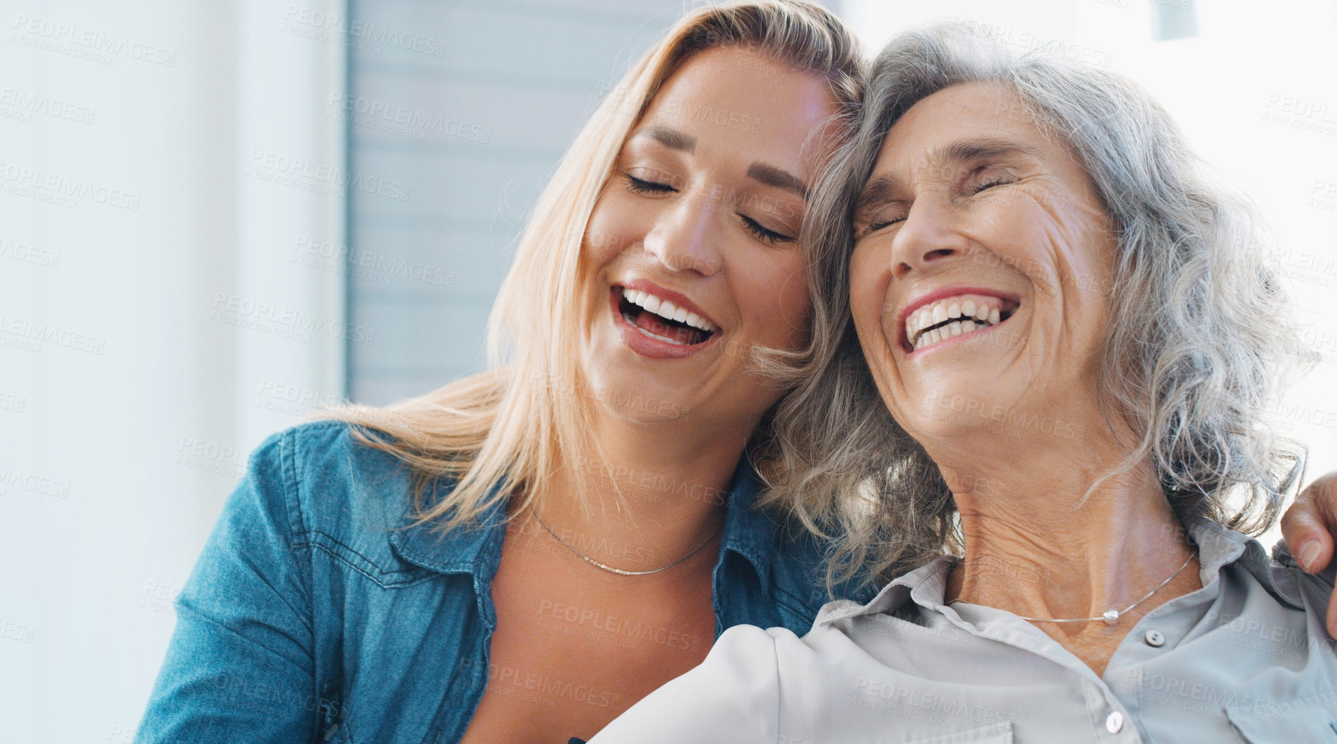 Buy stock photo Shot of a young woman spending quality time with her mother at home