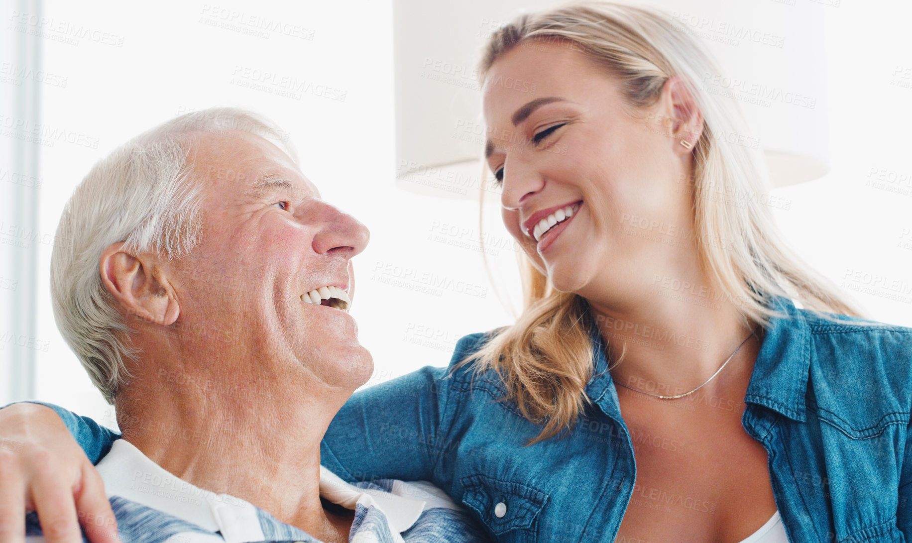 Buy stock photo Shot of a young woman spending quality time with her father at home