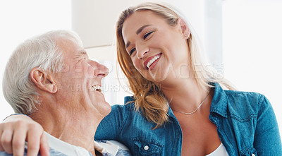 Buy stock photo Shot of a young woman spending quality time with her father at home