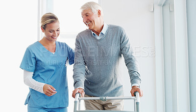 Buy stock photo Shot of a senior man using a walker with the assistance of a young nurse