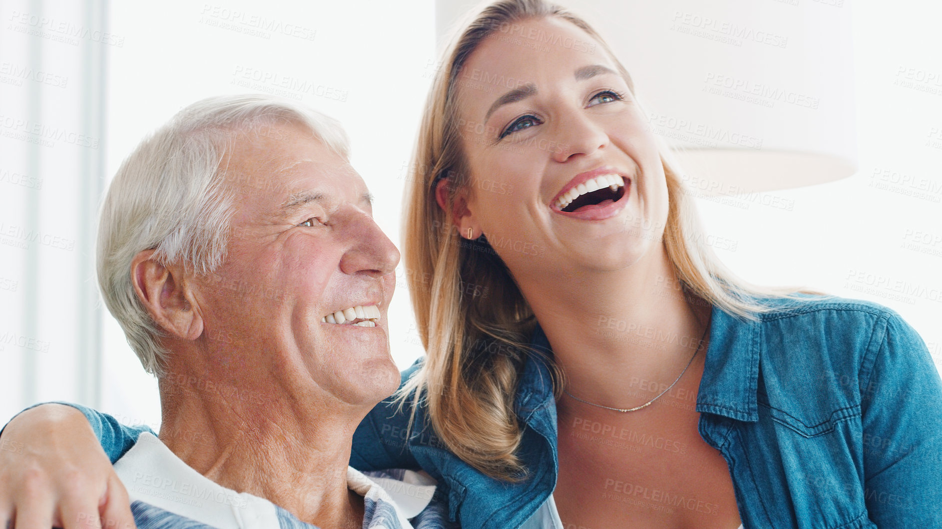 Buy stock photo Shot of a young woman spending quality time with her father at home